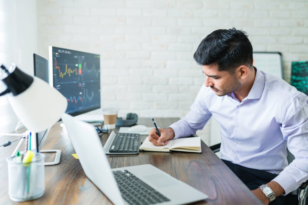 Trader reviewing evaluation dashboard and trade performance metrics