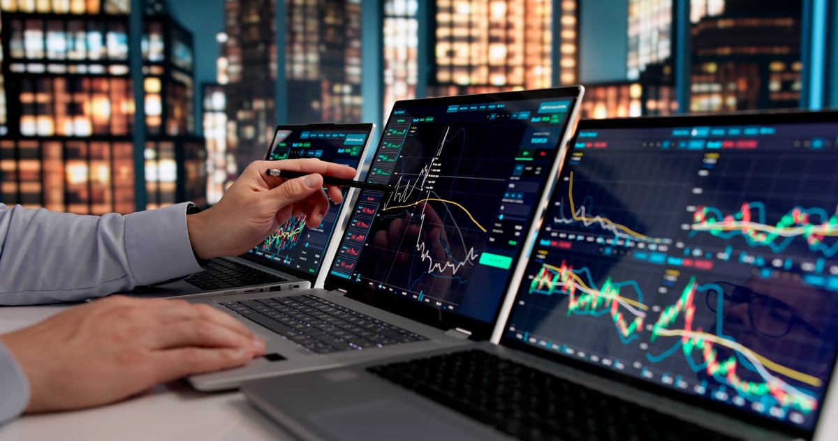 Trader analyzing reconstructed trade data on a laptop